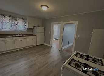 a kitchen with stainless steel appliances granite countertop a stove and a refrigerator