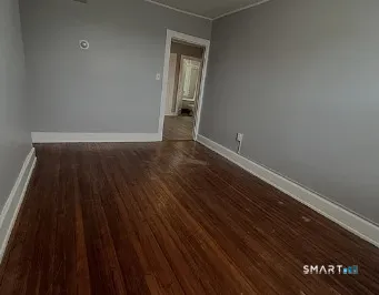 a view of a room with wooden floor