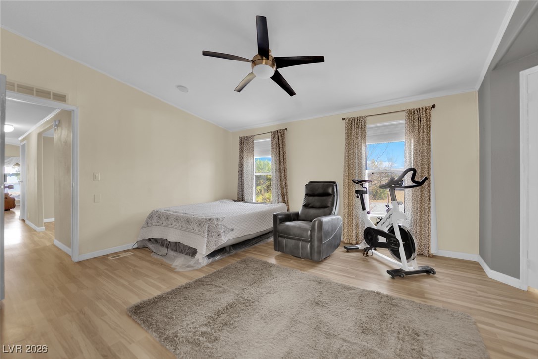 5550 Vicki Ann Road Pahrump, NV 89048 - Photo 20 of 44 Bedroom with light wood-type flooring, a ceiling fan, and crown molding