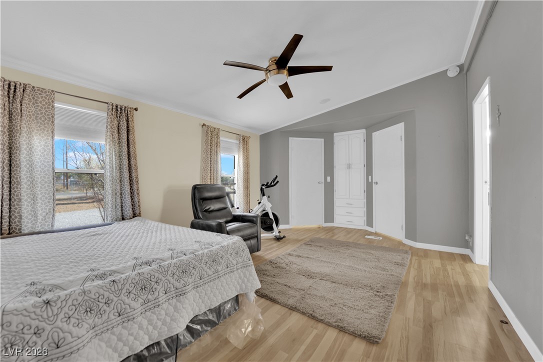 5550 Vicki Ann Road Pahrump, NV 89048 - Photo 21 of 44 Bedroom featuring light wood finished floors, crown molding, a ceiling fan, and lofted ceiling