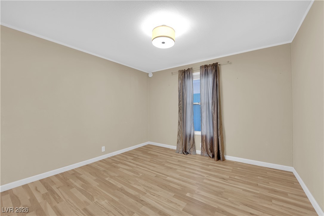 5550 Vicki Ann Road Pahrump, NV 89048 - Photo 23 of 44 Spare room featuring crown molding and light wood-style flooring