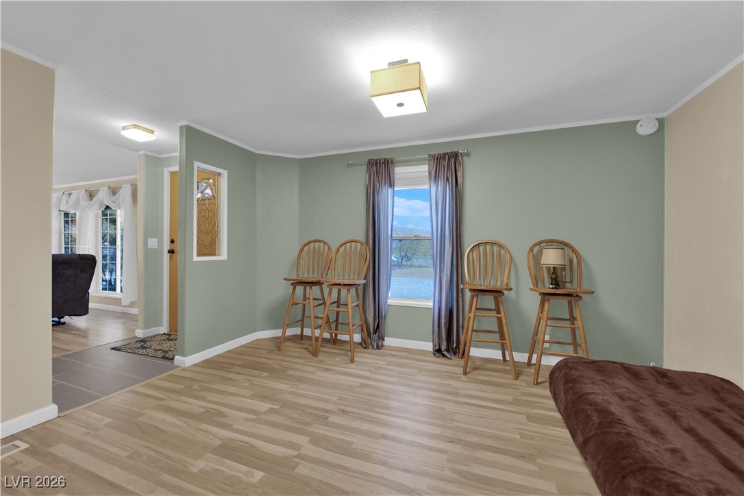 5550 Vicki Ann Road Pahrump, NV 89048 - Photo 24 of 44 Sitting room with light wood-type flooring and ornamental molding