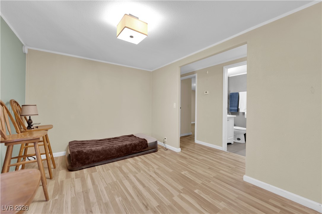 5550 Vicki Ann Road Pahrump, NV 89048 - Photo 25 of 44 Sitting room with light wood-style floors and crown molding
