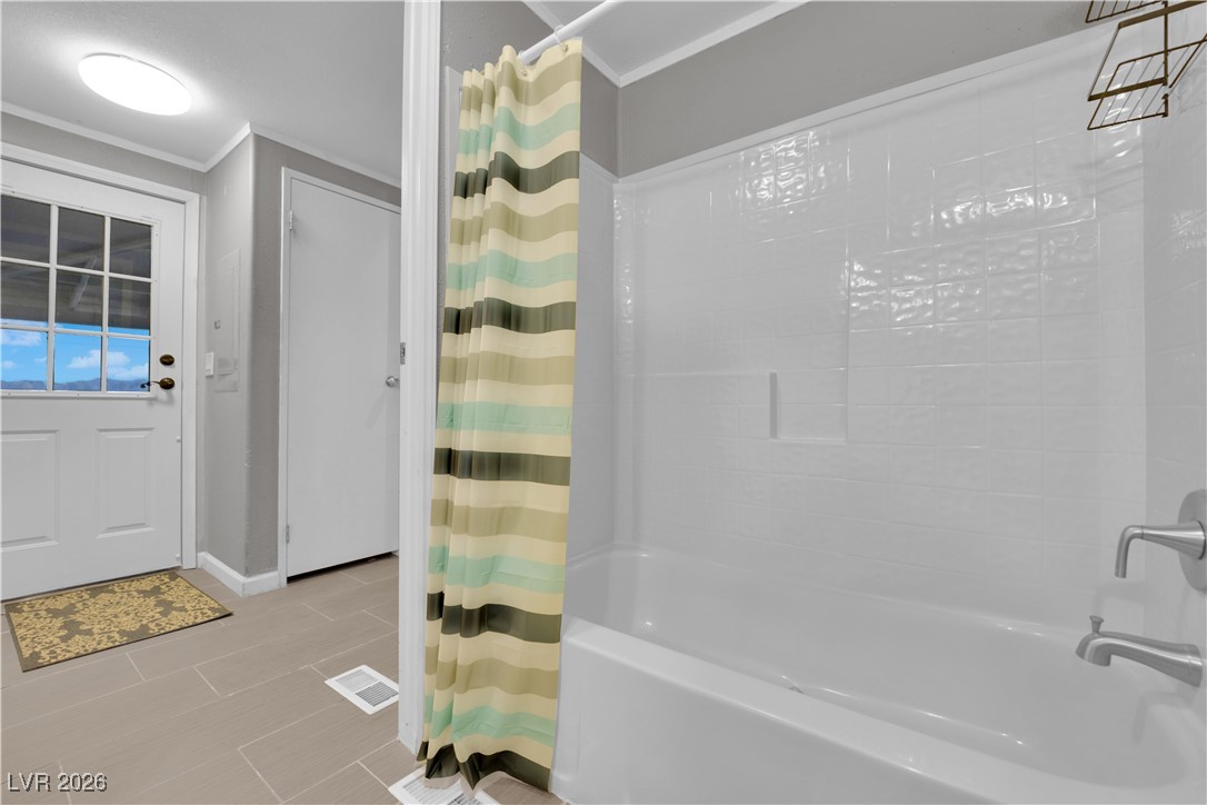 5550 Vicki Ann Road Pahrump, NV 89048 - Photo 26 of 44 Full bath featuring shower / tub combo with curtain and ornamental molding