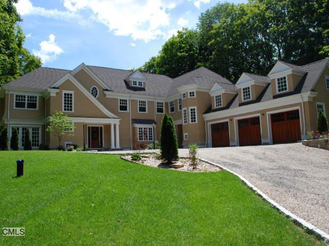 71 Godfrey Road West Weston, CT 06883 - Photo 1 of 1 a front view of a house with a yard and trees