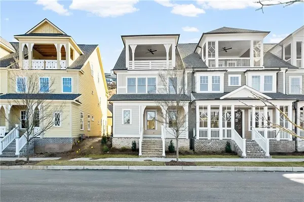 a front view of a residential apartment building with a yard