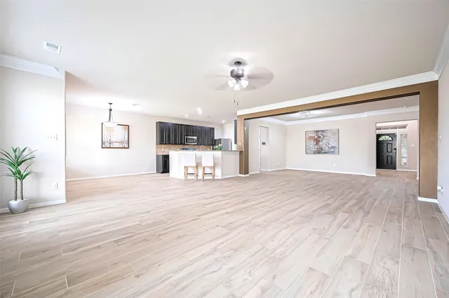 a big room with wooden floor and windows