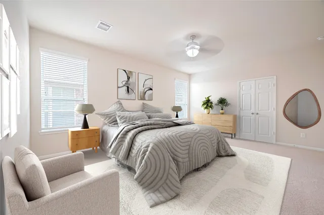 a spacious bedroom with a bed and a chandelier