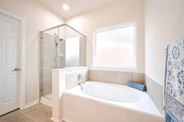 a white bath tub sitting next to a white sink