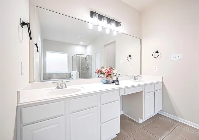 a bathroom with a sink vanity granite and a mirror