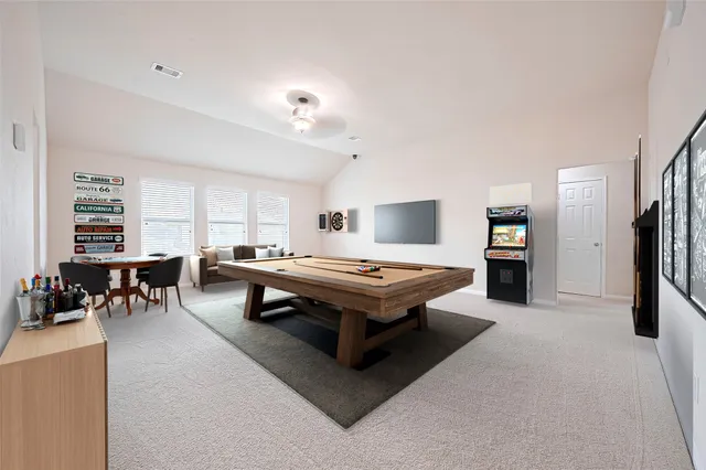 a living room with furniture and a dining table