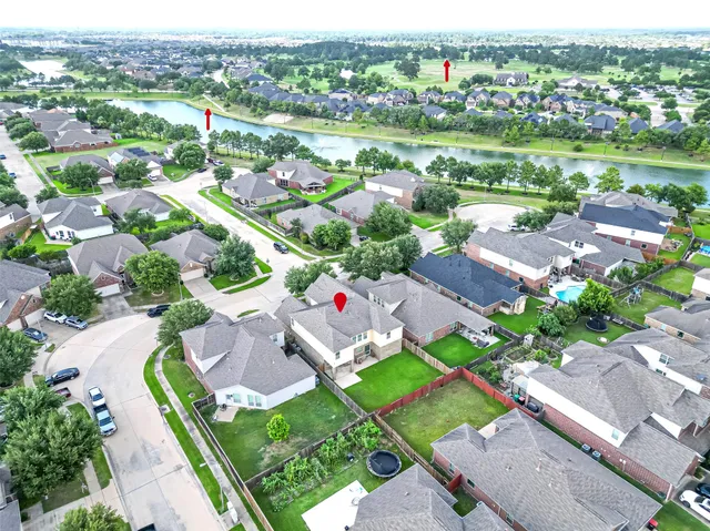 an aerial view of residential houses with outdoor space and street view