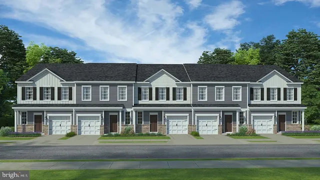 a aerial view of a brick house next to a yard