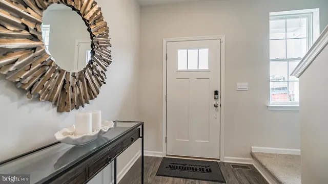 a view of a livingroom with furniture and hardwood floor