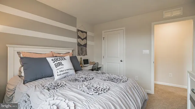 a bedroom with a large bed and a closet
