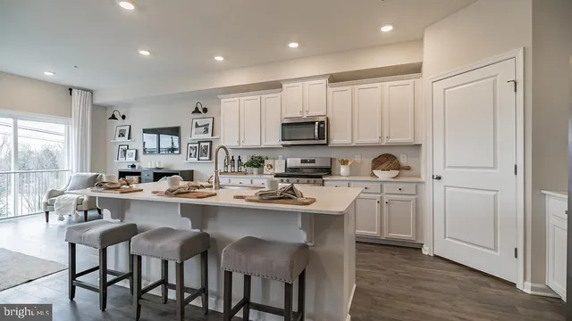 a kitchen with appliances a sink cabinets and a window