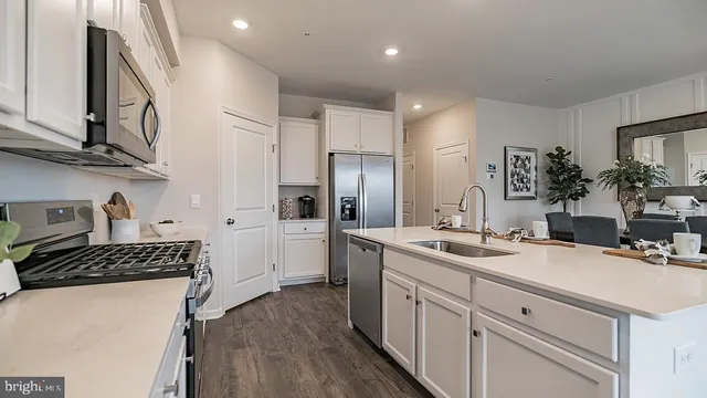 a kitchen with a sink stove and refrigerator