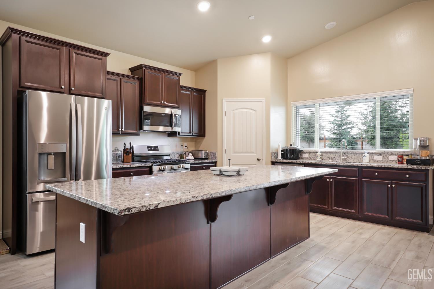 Undisclosed Address Shafter, CA 93263 - Photo 12 of 28 a kitchen with stainless steel appliances granite countertop a sink stove refrigerator and cabinets