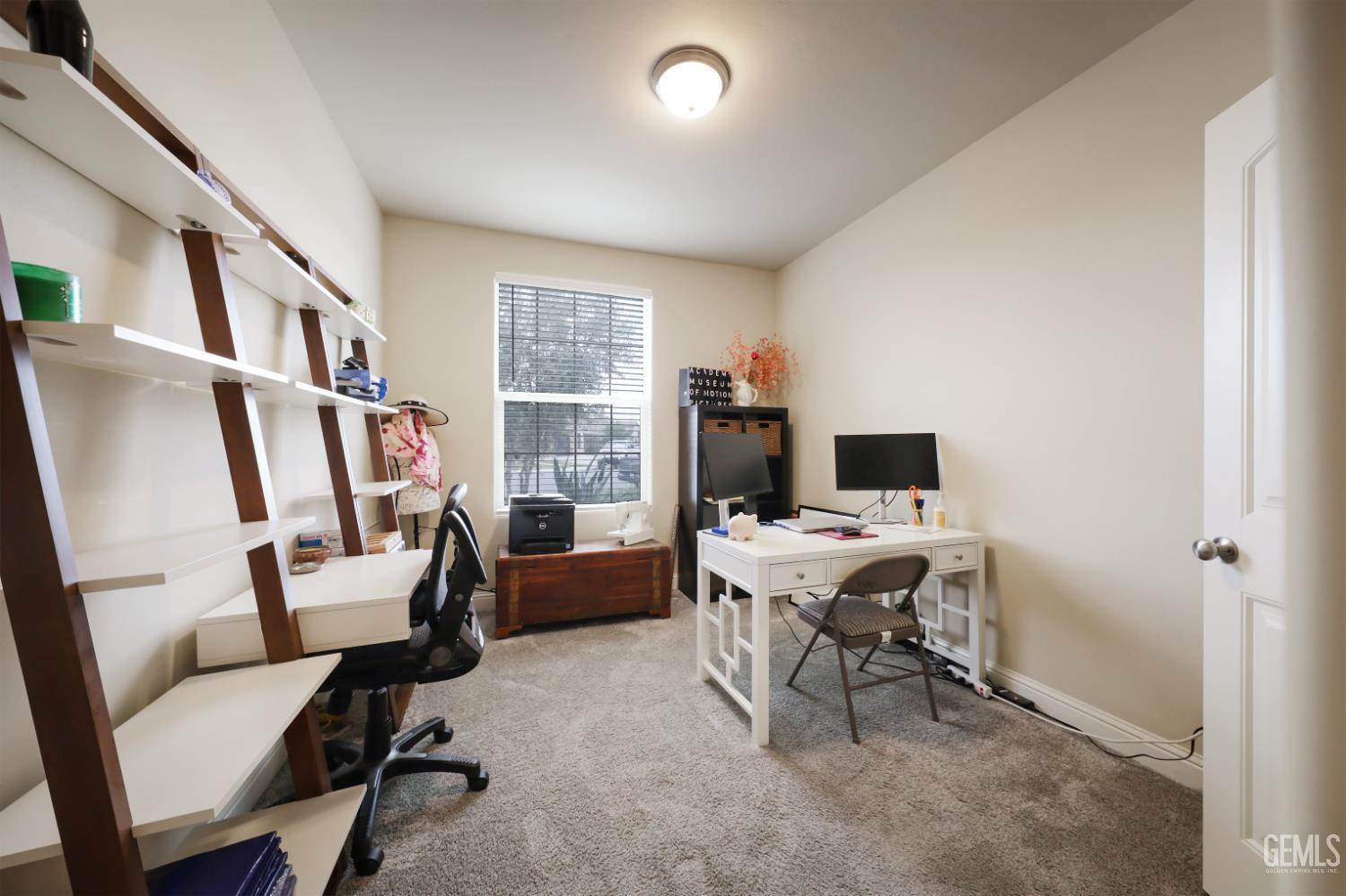 Undisclosed Address Shafter, CA 93263 - Photo 16 of 28 a view of a workspace with furniture and a window