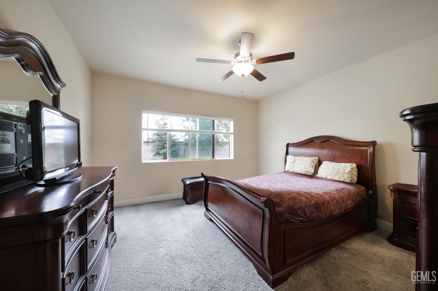 Undisclosed Address Shafter, CA 93263 - Photo 19 of 28 a bedroom with a bed and a flat screen tv