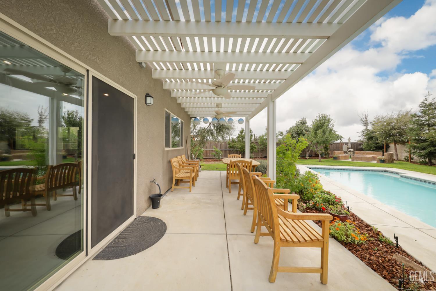 Undisclosed Address Shafter, CA 93263 - Photo 26 of 28 a view of a swimming pool with outdoor seating and plants