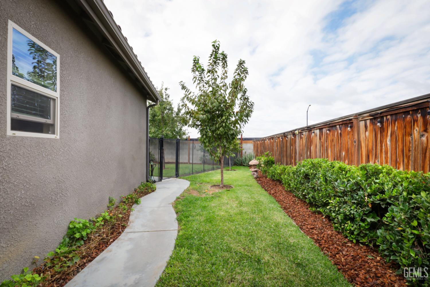Undisclosed Address Shafter, CA 93263 - Photo 27 of 28 a view of a backyard with pathway