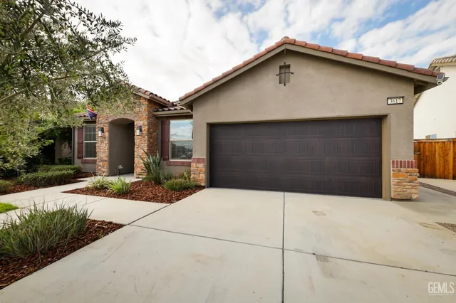 a front view of a house with garage
