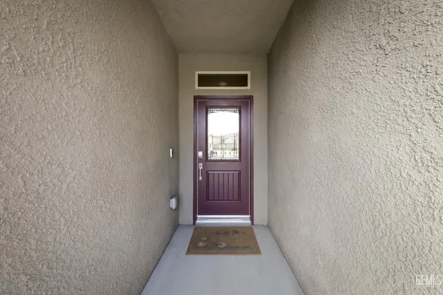 a view of a hallway with wooden floor and a hallway