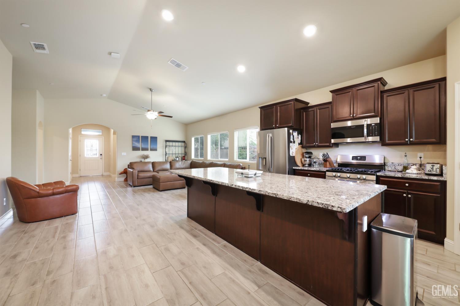 Undisclosed Address Shafter, CA 93263 - Photo 10 of 28 a kitchen with stainless steel appliances granite countertop wooden cabinets a stove top oven a sink and dishwasher