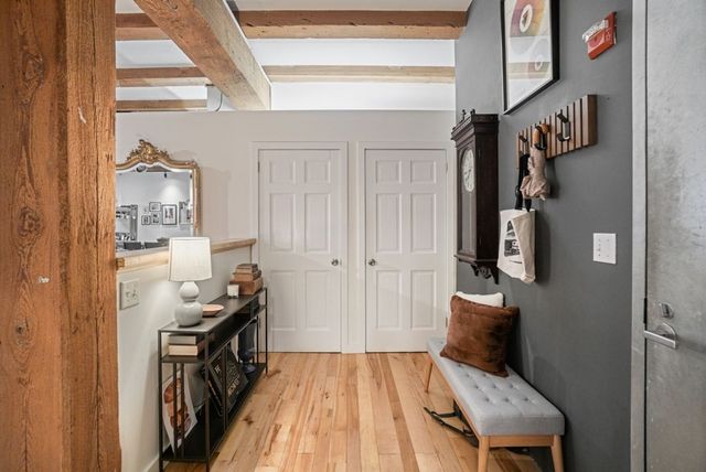 a view of a livingroom with wooden floor and furniture