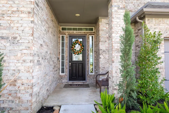 a view of a door and chair front of house