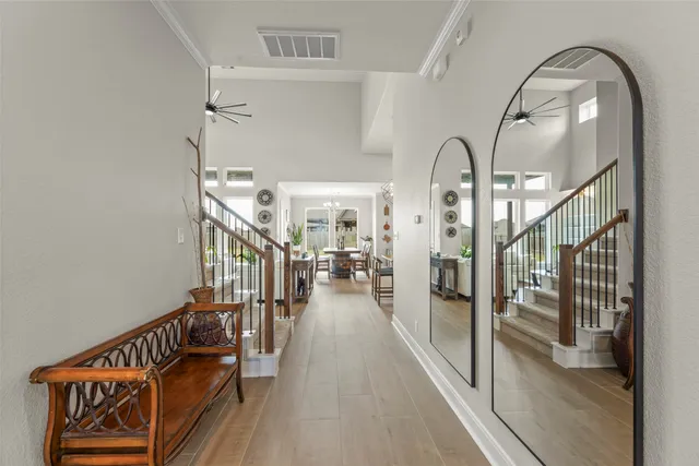a view of staircase and living room with wooden floor