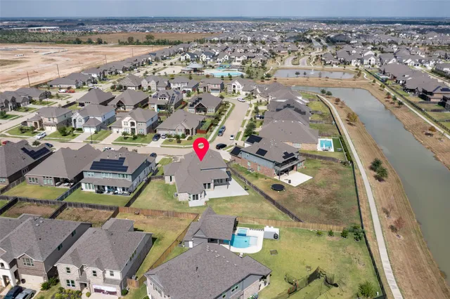 an aerial view of a house with a lake view