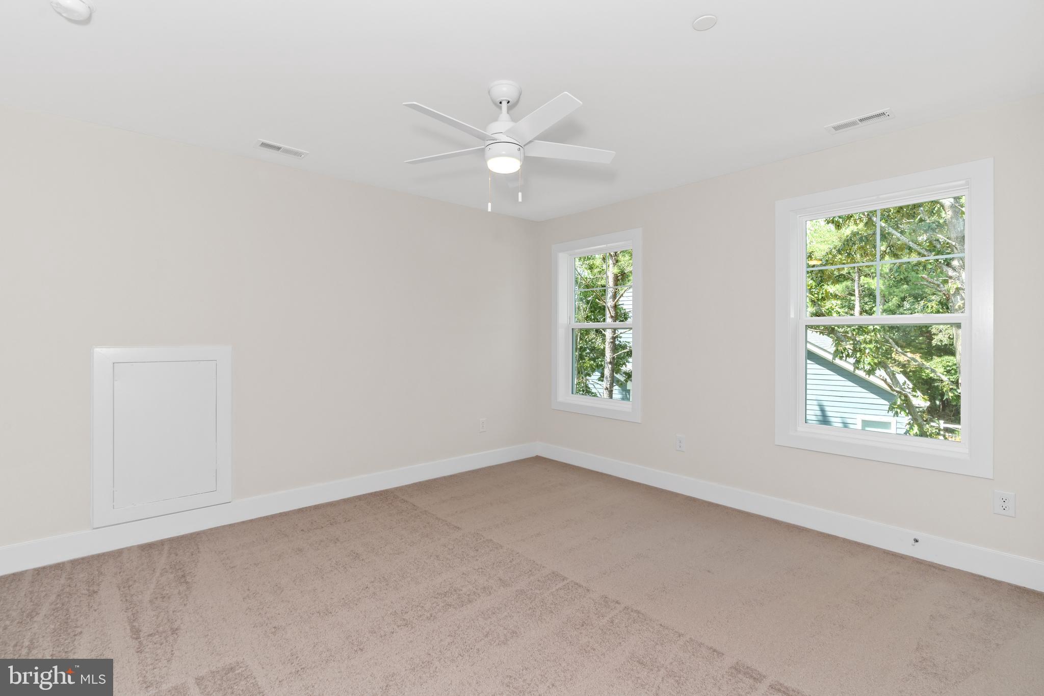 22580 Hummingbird Road, Unit 17 Ellendale, DE 19941 - Photo 12 of 75 an empty room with a window and a fan