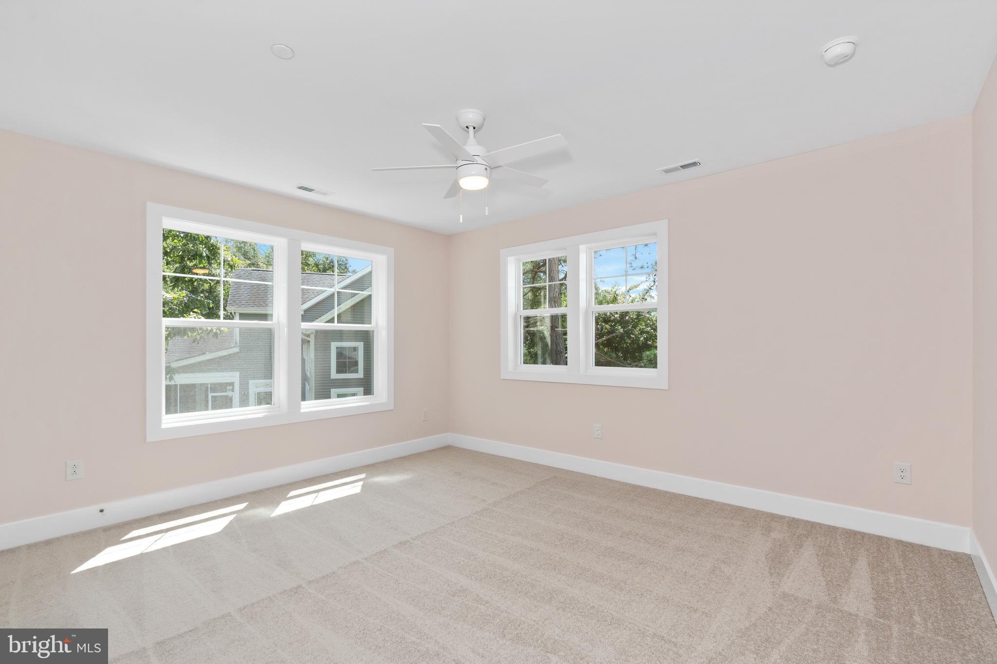 22580 Hummingbird Road, Unit 17 Ellendale, DE 19941 - Photo 19 of 75 an empty room with a window and a fan
