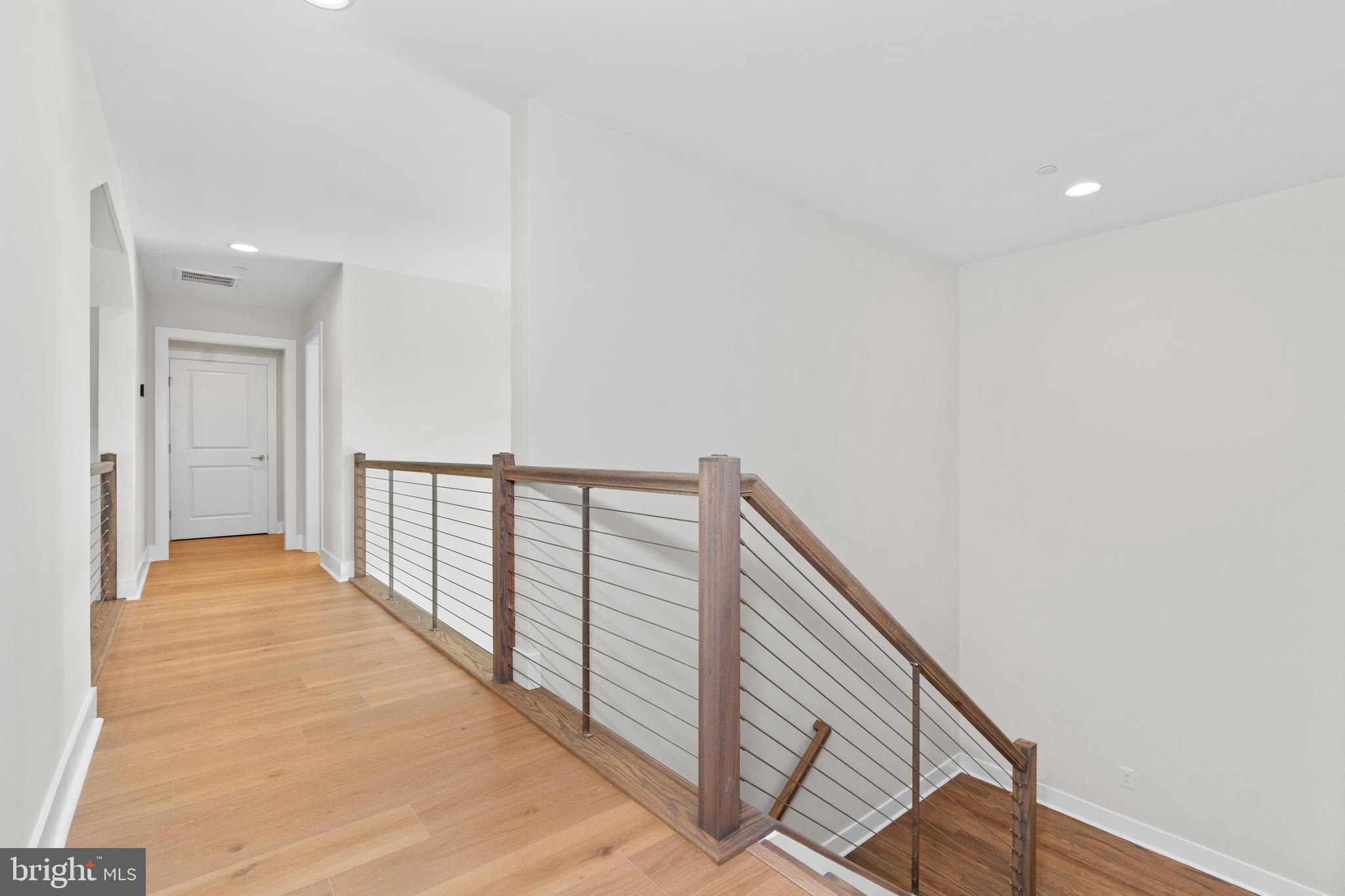 22580 Hummingbird Road, Unit 17 Ellendale, DE 19941 - Photo 24 of 75 a view of a hallway with wooden floor and stairs