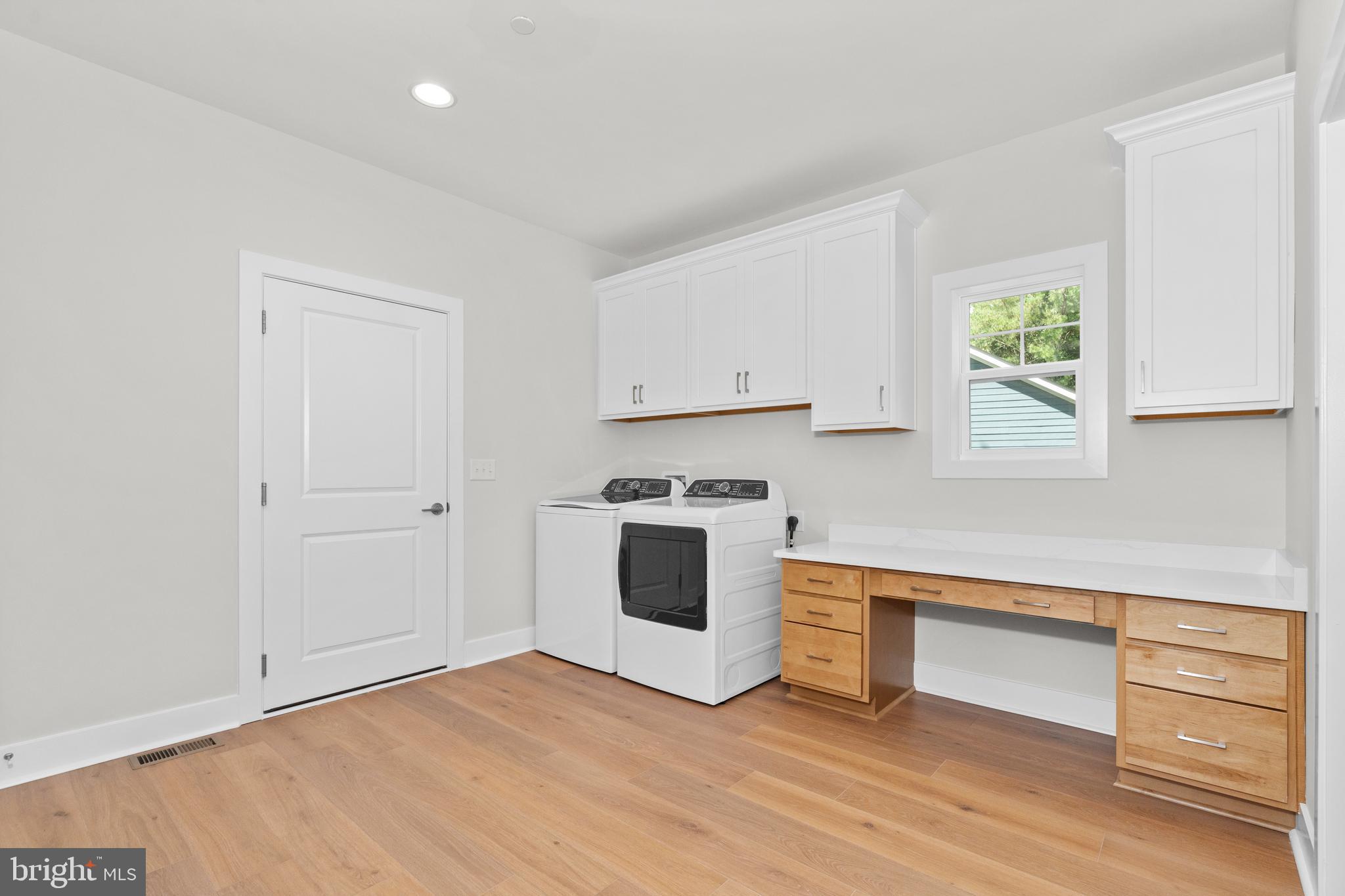22580 Hummingbird Road, Unit 17 Ellendale, DE 19941 - Photo 25 of 75 a view of a kitchen with wooden floor and electronic appliances