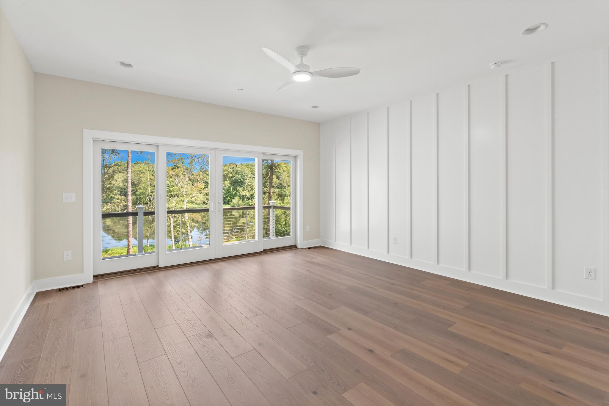22580 Hummingbird Road, Unit 17 Ellendale, DE 19941 - Photo 42 of 75 wooden floor in an empty room with a window
