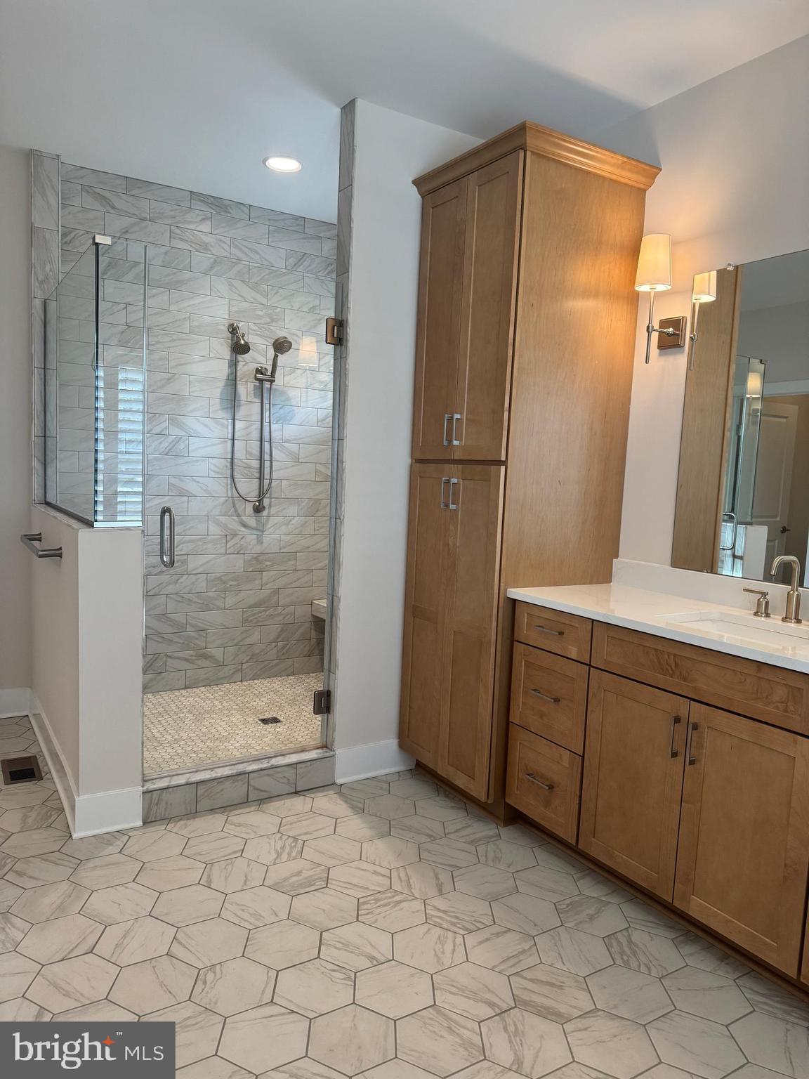 22580 Hummingbird Road, Unit 17 Ellendale, DE 19941 - Photo 60 of 75 a bathroom with a glass shower door and a sink