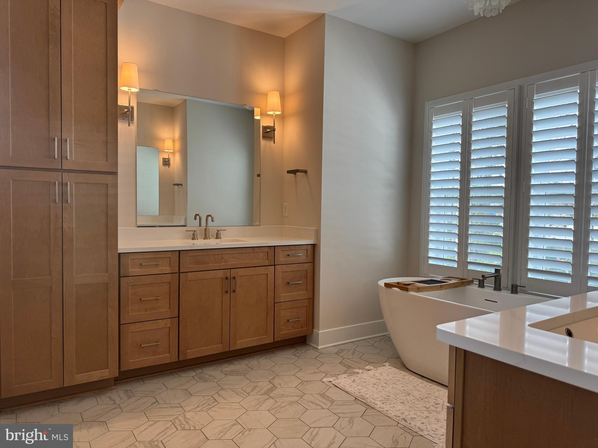22580 Hummingbird Road, Unit 17 Ellendale, DE 19941 - Photo 62 of 75 a spacious bathroom with a double vanity sink mirror and double