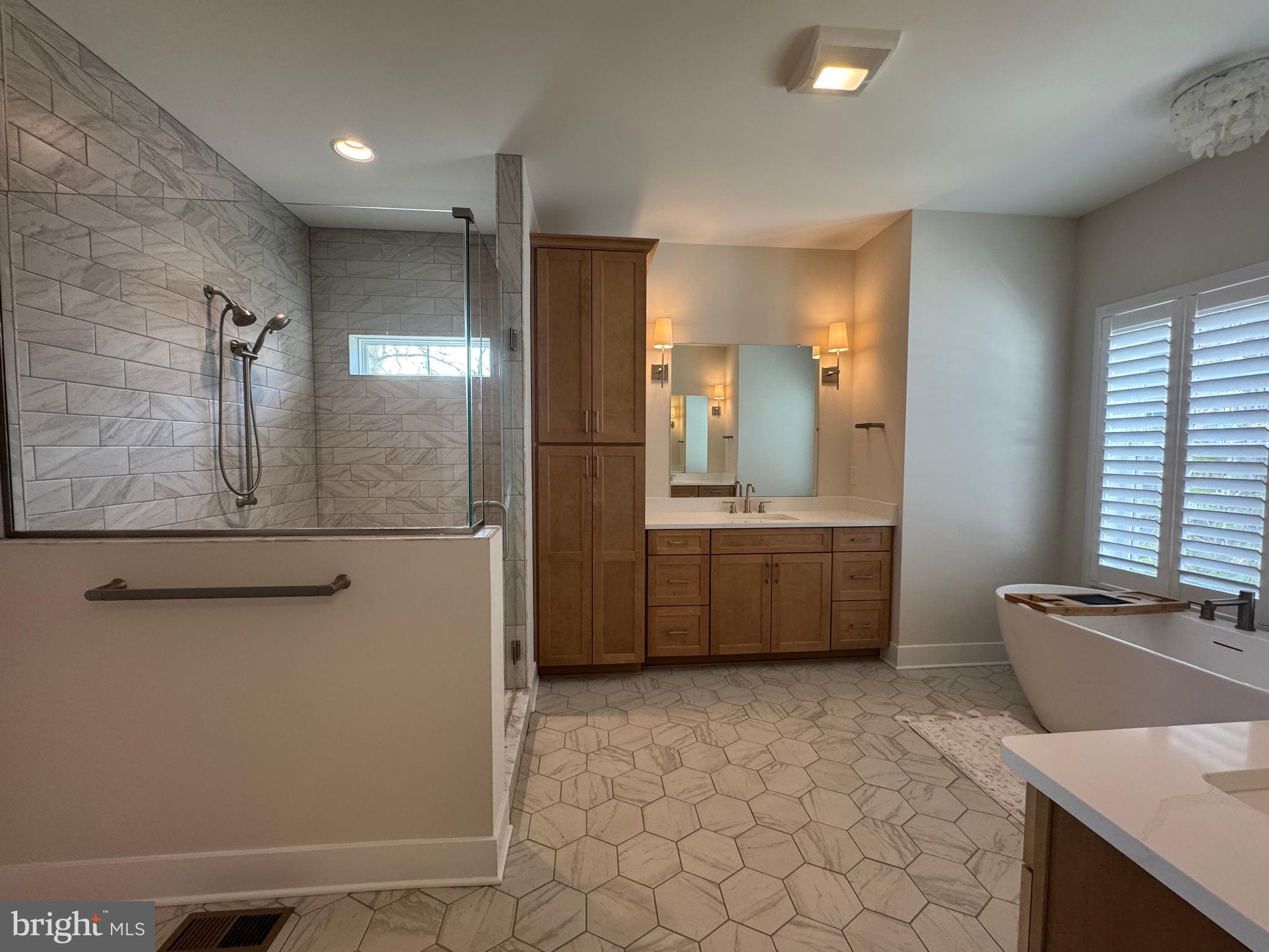 22580 Hummingbird Road, Unit 17 Ellendale, DE 19941 - Photo 66 of 75 a bathroom with a double vanity sink a mirror and a bathtub