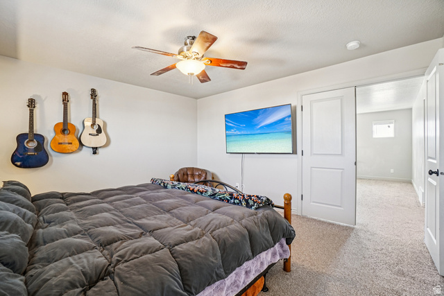 203 North 1900th Street West Mapleton, UT 84664 - Photo 15 of 48 Carpeted room with a ceiling fan, white walls, and a wall-mounted television