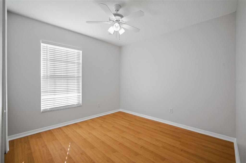 12407 Dawn Vista Drive Riverview, FL 33578 - Photo 12 of 44 wooden floor in an empty room with a window
