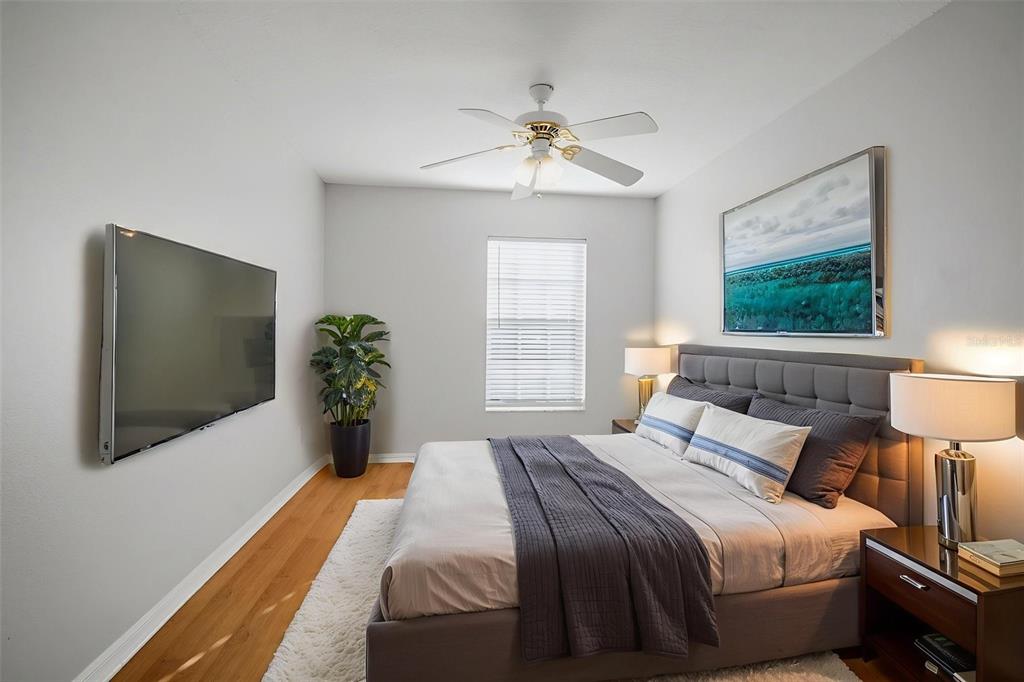 12407 Dawn Vista Drive Riverview, FL 33578 - Photo 18 of 44 a bedroom with a bed and a flat screen tv