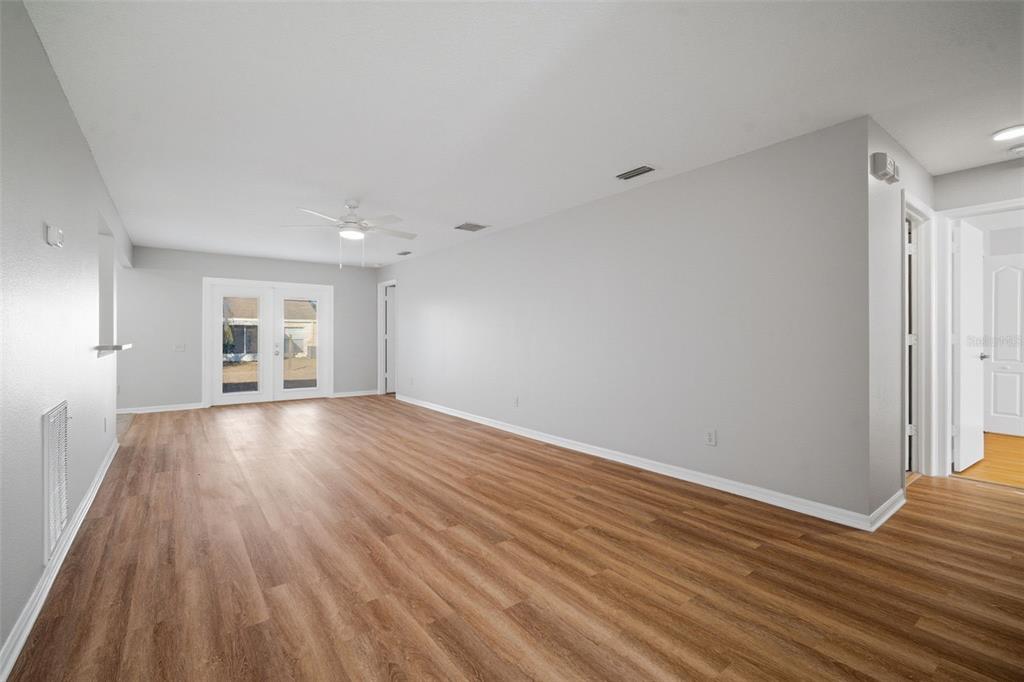 12407 Dawn Vista Drive Riverview, FL 33578 - Photo 19 of 44 a view of empty room with wooden floor and fan