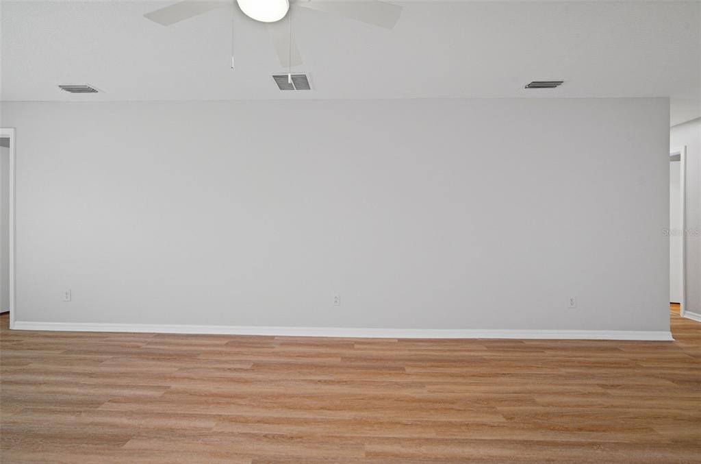 12407 Dawn Vista Drive Riverview, FL 33578 - Photo 20 of 44 a view of an empty room with wooden floor