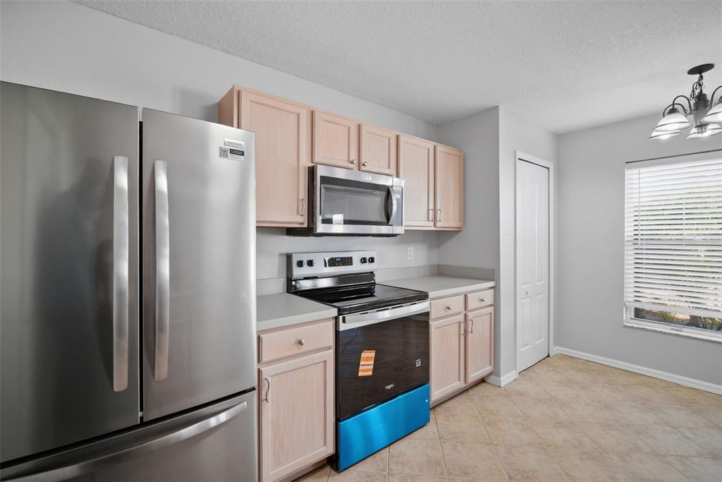 12407 Dawn Vista Drive Riverview, FL 33578 - Photo 34 of 44 a kitchen with stainless steel appliances granite countertop a refrigerator stove and microwave