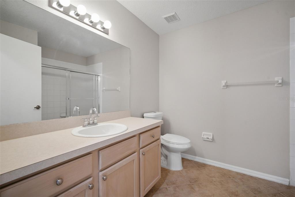 12407 Dawn Vista Drive Riverview, FL 33578 - Photo 36 of 44 a bathroom with a sink a toilet and a mirror