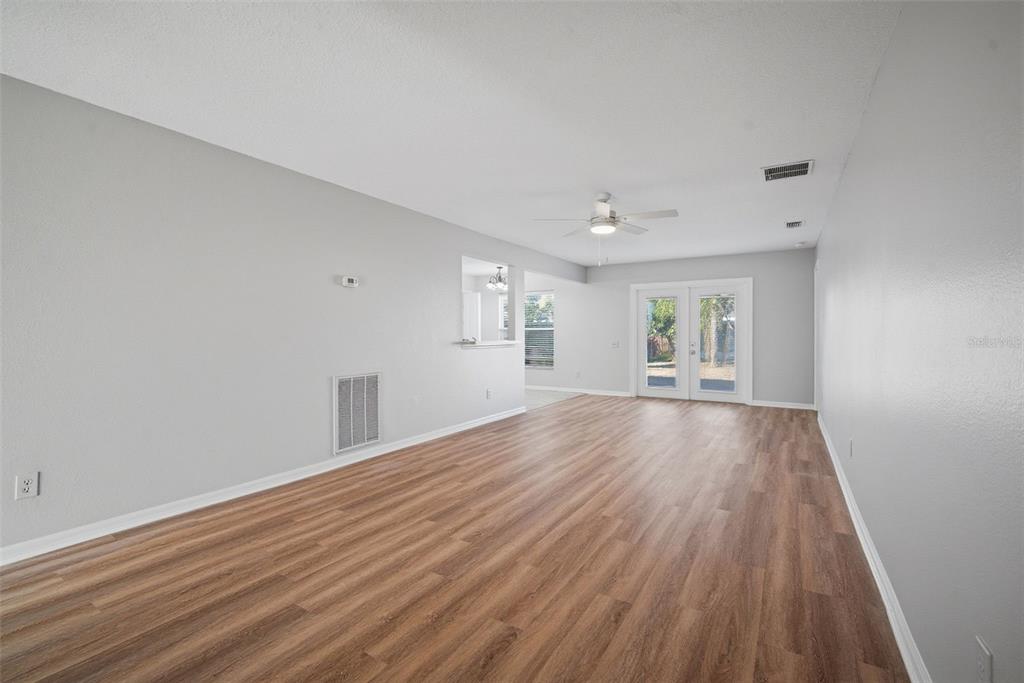 12407 Dawn Vista Drive Riverview, FL 33578 - Photo 4 of 44 a view of an empty room with wooden floor and a window