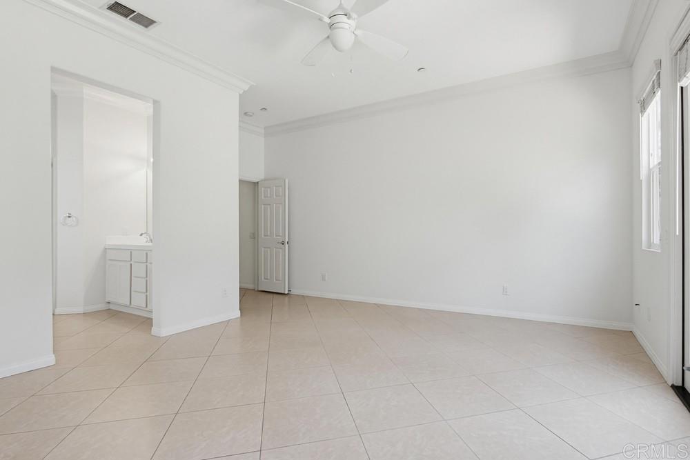 672 Inverlochy Drive Fallbrook, CA 92028 - Photo 33 of 75 an empty room with a ceiling fan and carpet